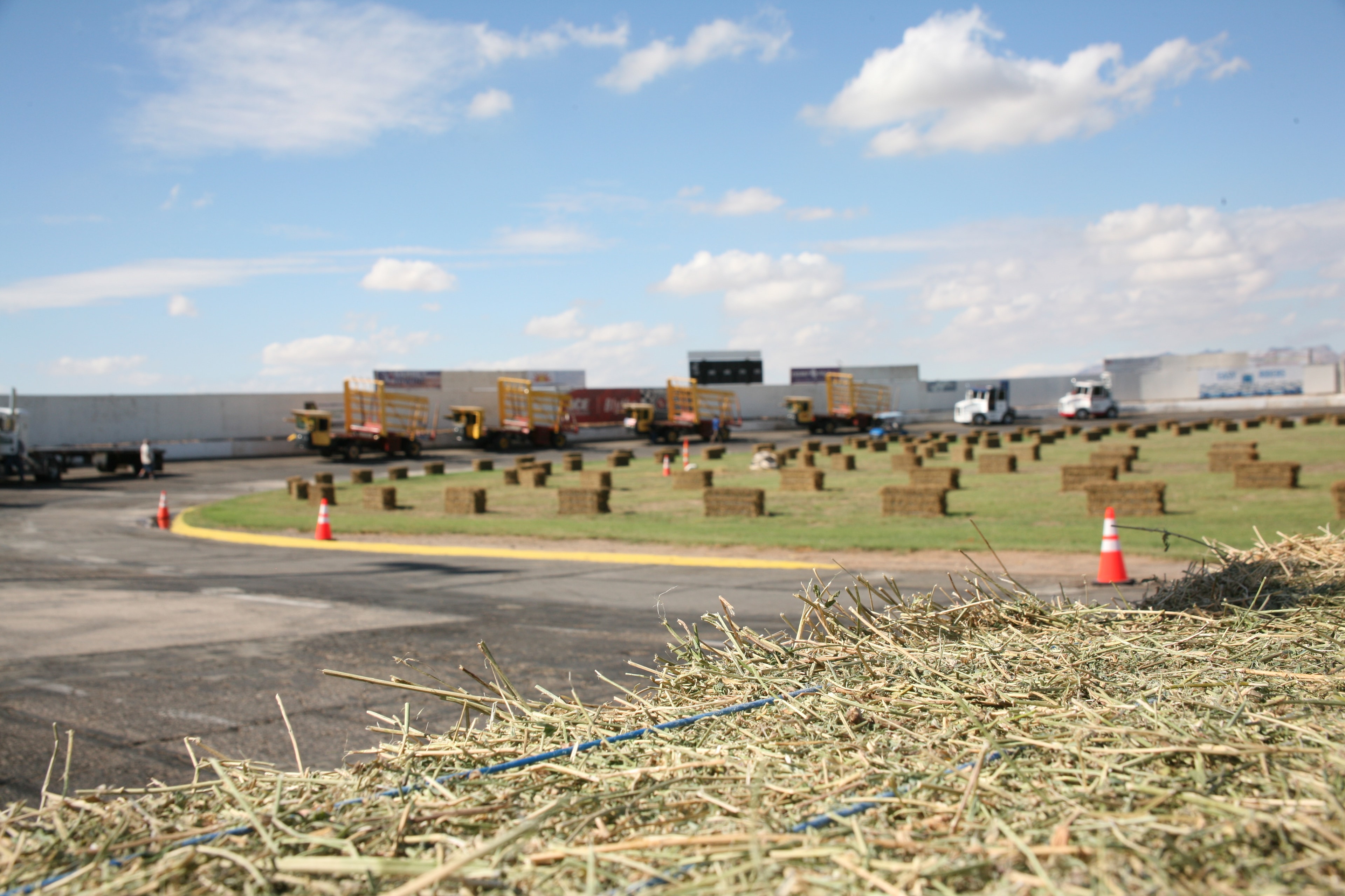 Hay bales and field loaders spread across the competition field