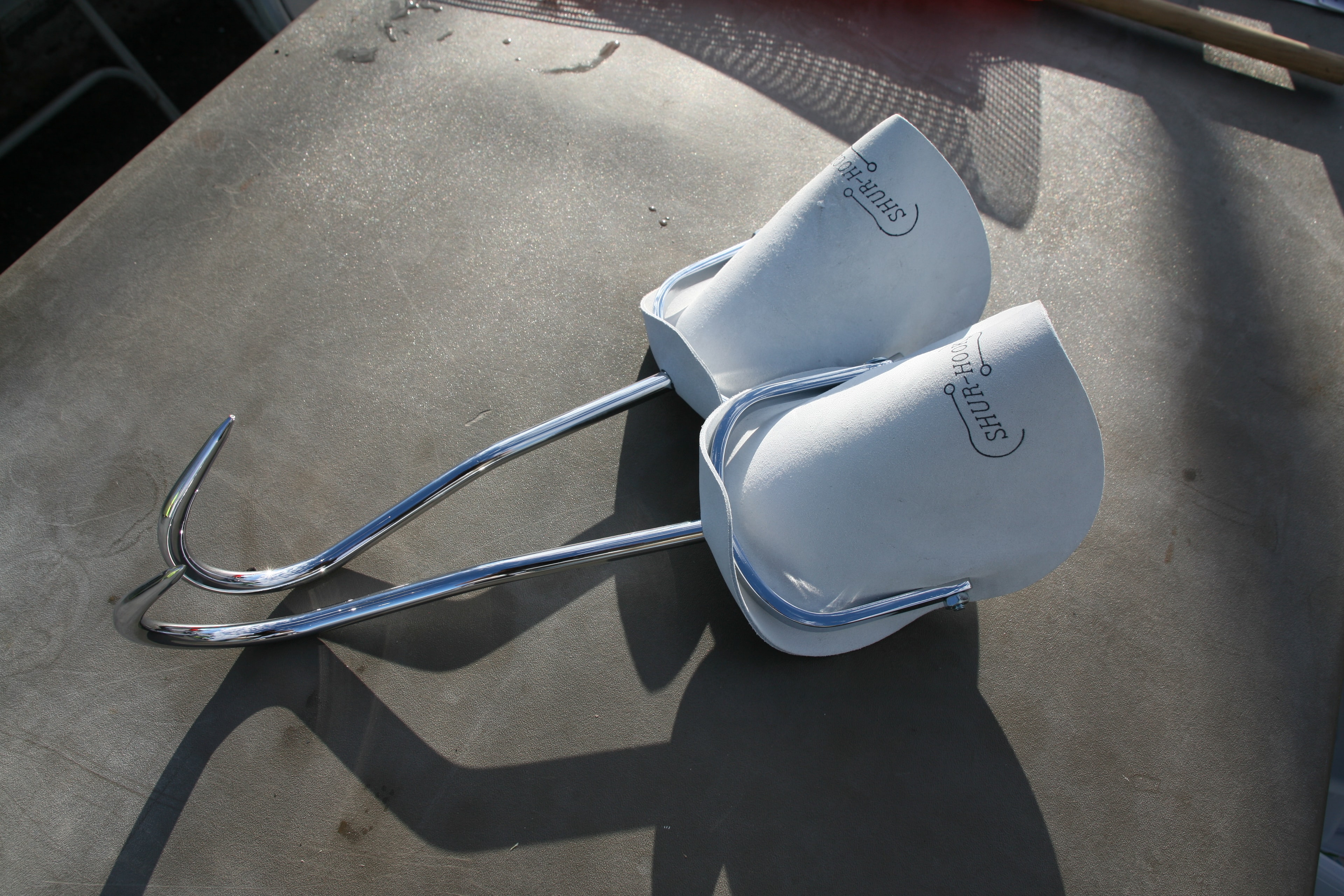 Pair of Shur-Hook hay hooks resting on a surface
